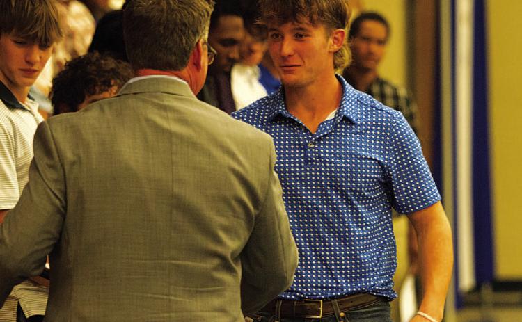 HUNTER KING | DISPATCH RECORD Reed Jerome receives the Battlin’ Badger award from head coach Troy Rogers.