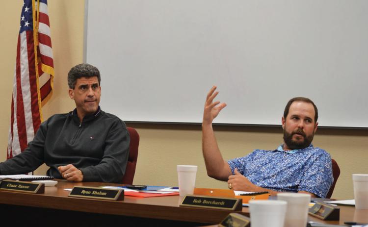 erick mitchell | dispatc h record Superintendent Dr. Chane Rascoe, left, and Lampasas ISD Board President Ryan Shahan discuss with trustees what they want to see with design plans from WRA Architects.
