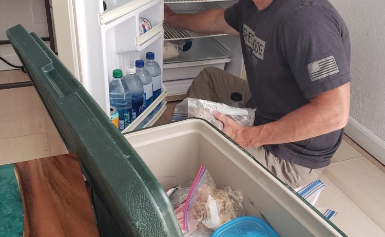 In a bed and breakfast in New Mexico, columnist Alexandria Randolph’s husband, Chris, packs fresh food from the hotel refrigerator into a cooler as they prepare for the next stage of their July road trip. Alexandria Randolph | Dispatch record