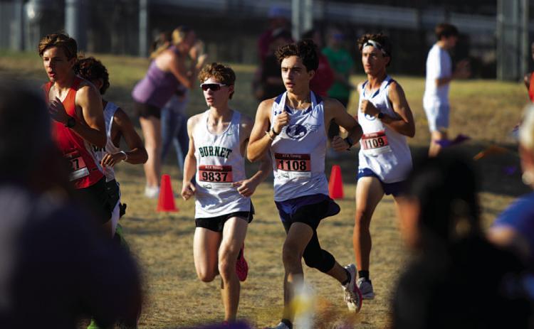 Royce Clary, left, and Tyler Ecker race around the trail during the district cross country meet. HUNTER KING | DISPATCH RECORD