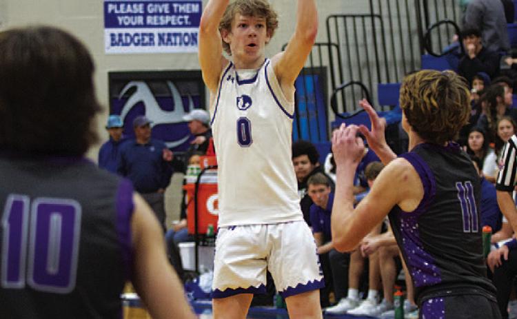 HUNTER KING | DISPATCH RECORD Peyton Sisson shoots over a defender for three of his 25 points Friday night.