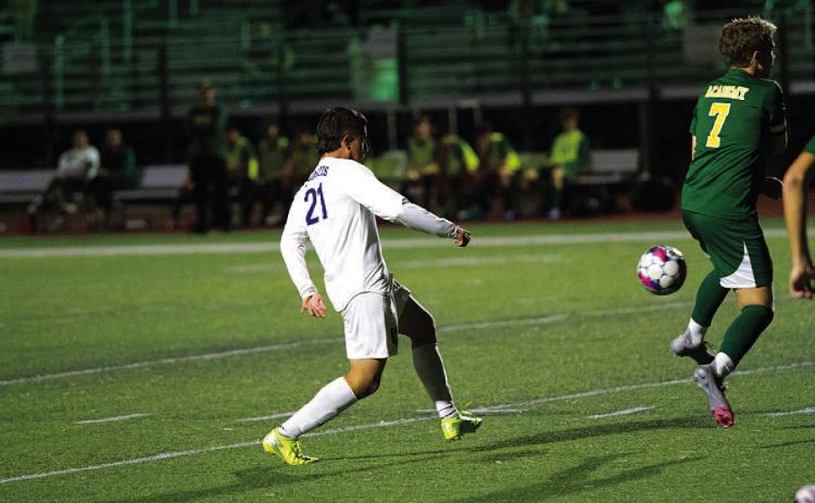 Juan Munoz picks out a pass to a teammate during the Badgers’ match against Academy. HUNTER KING | DISPATCH RECORD