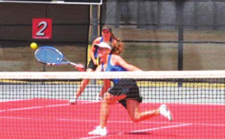 Abby Valdez runs to hit a shot near the net during her match with partner Kailr Clements at regionals. COURTESY PHOTO
