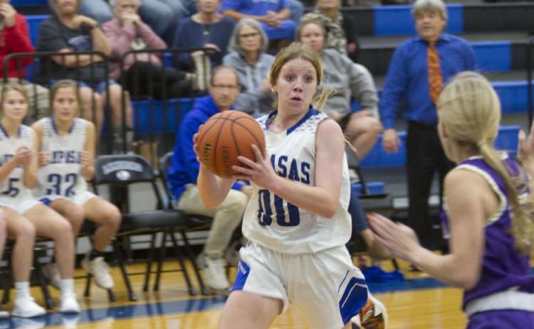 Aspen Wheeler drives toward the bucket against a Marble Falls defender on her way to completing an and-one basket to put the Badgers up by two points late in Tuesday’s game. HUNTER KING | DISPATCH RECORD