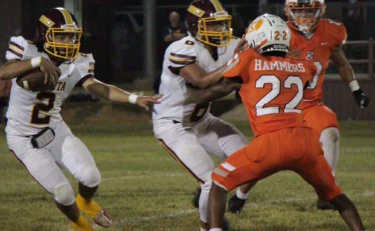 Tim Juarez runs past a Rotan defender while Luis Hernandez lays a block during the Hornets’ win last Friday. JESSICA MALDONADO | DISPATCH RECORD