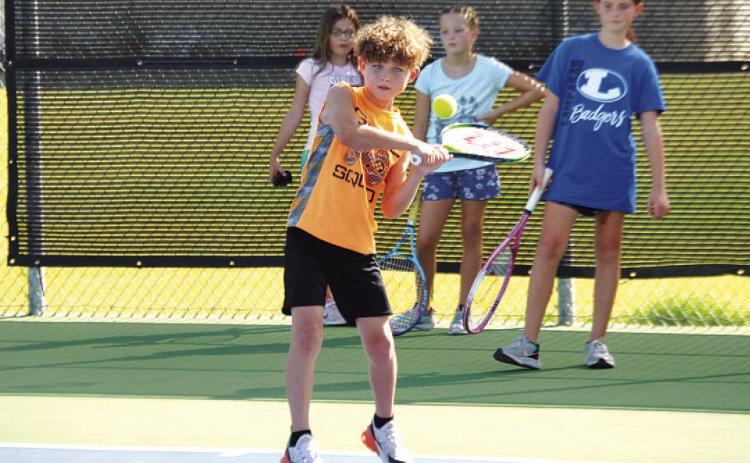 FILE PHOTO Kurt Hannabass works on a forehand shot during last summer’s tennis camp in July.