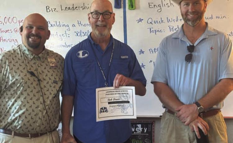 Lampasas High School has named Bob Davis, center, its Teacher of the Month for August. Assistant Principal Ryan Race, at left, said Davis “is an amazing English I and General Employability teacher. He shows what a good teacher looks like with his calm demeanor and great relationships with his students.” Clay Phillips of Texas Farm Bureau Insurance also was on hand to recognize Davis. COURTESY PHOTO