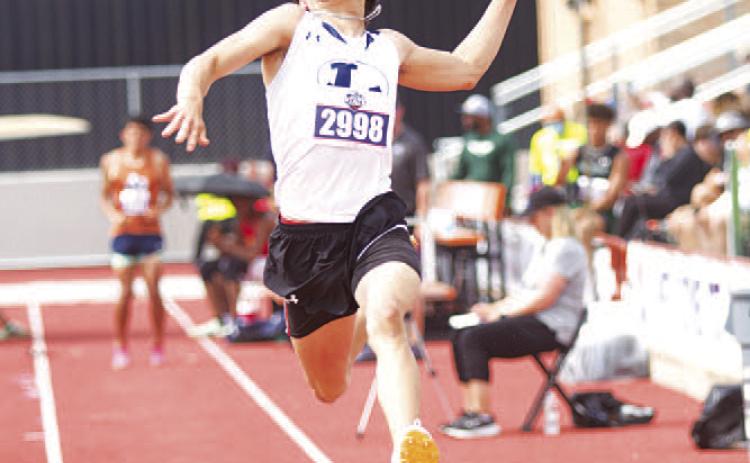 HUNTER KING | DISPATCH RECORD Asa White flies through the air during a jump attempt at the state track meet in Austin last Thursday.