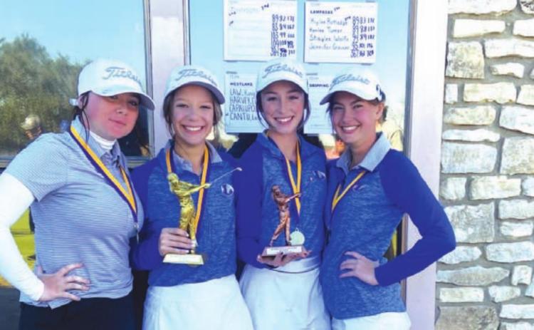 Jennifer Greiner, left, Kenlee Turner, Kylee Rutledge and Shaylee Wolfe pose for a photo with their trophy after winning in Marble Falls. COURTESY PHOTO