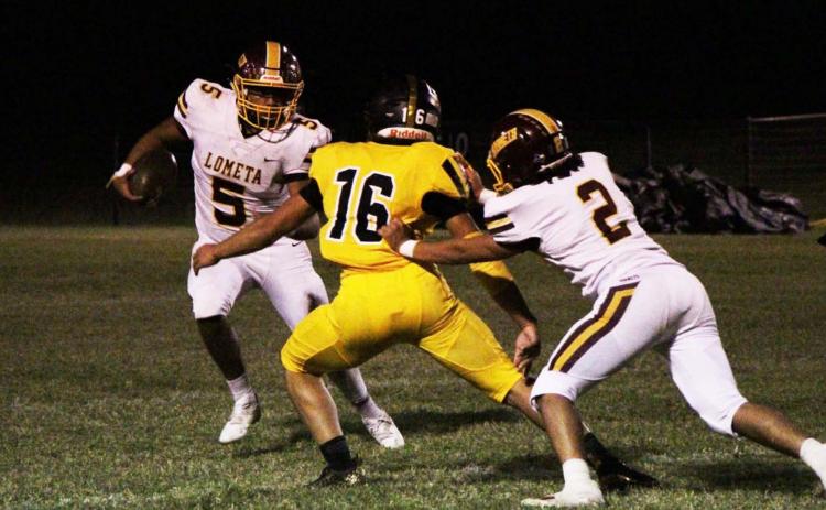 Elijah Gonzales looks for room to run against Jonesboro, while Tim Juarez blocks a defender during the game last Friday. JESSICA MALDONADO | DISPATCH RECORD