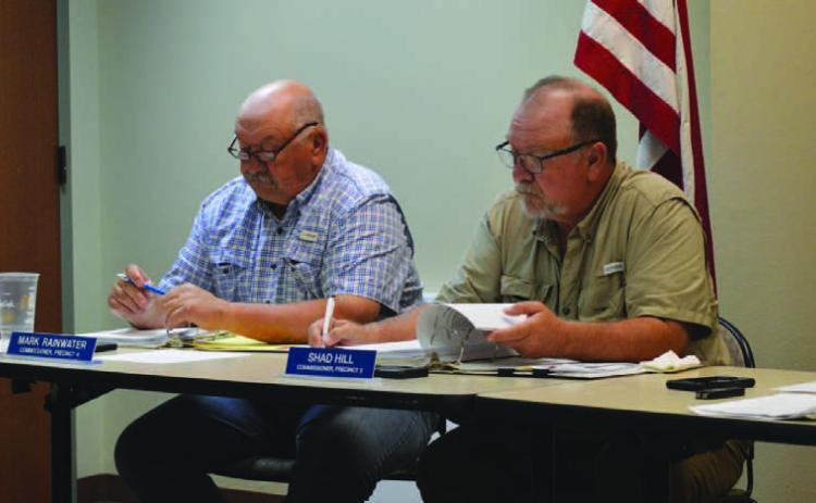 Commissioners Mark Rainwater, left, and Shad Hill review agenda materials at Monday’s Commissioners Court meeting, held at the county annex conference room. The next regular meeting will return to the courthouse’s first-floor courtroom. ERICK MITCHELL | DISPATCH RECORD