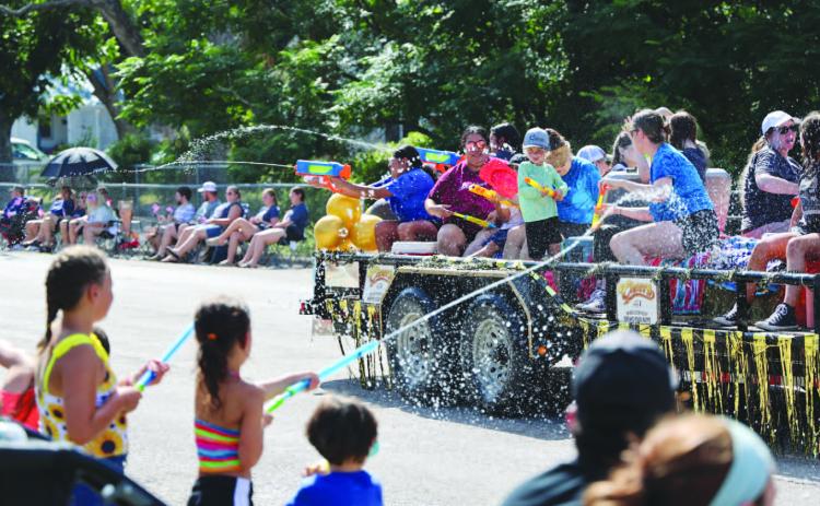 As is the tradition, Spring Ho Parade participants on floats and in the procession engage in a spirited water battle with the crowd. JOYCESARAH MCCABE | DISPATCH RECORD