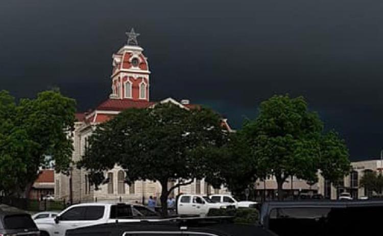 Storm clouds hover over downtown square on stormy Monday