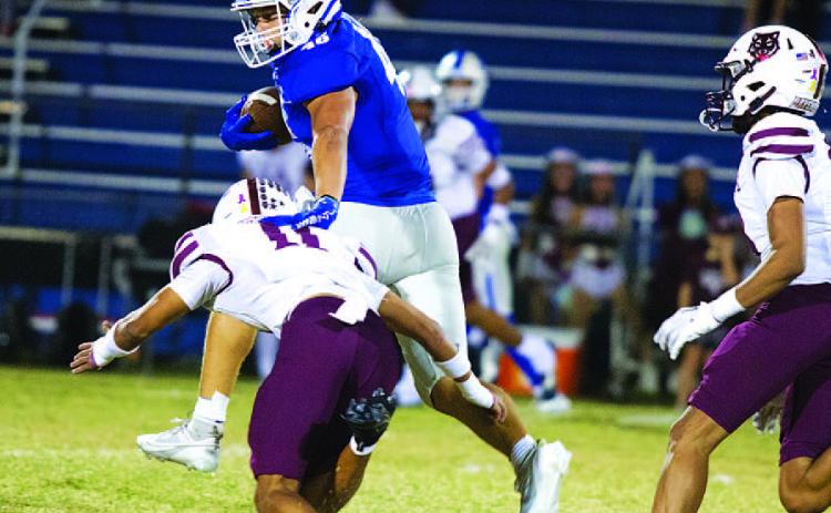 HUNTER KING | DISPATCH RECORD Haeagan Oncken makes a Davenport tackler miss as he runs up the middle of the field.