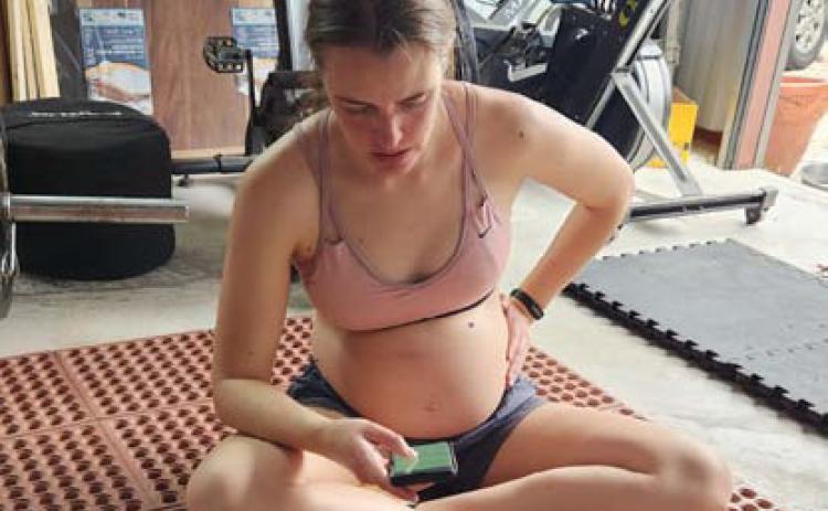 Columnist Alexandria Randolph rests post workout and logs her activity on a tracker app during her sixth month of pregnancy. Mothers who exercise during pregnancy have lower risk of pregnancy and labor complications. Alexandria Randolph | Lampasas Dispatch Record