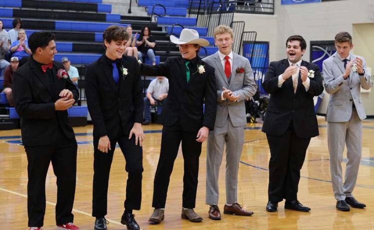 Brock Langford places a hand on the back of this year’s LHS Prom King Trent Seneca while the other nominees, Preston Isom, Dillon DuVall, Keaton Black and Benjamin Ybarra, clap to congratulate their colleague. JOYCESARAH MCCABE | DISPATCH RECORD
