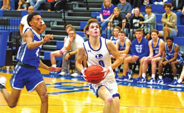 Nate Borchardt goes to the rim for a layup against Whitney in the same game he scored his 1,500th career point for the Badgers. HUNTER KING | DISPATCH RECORD