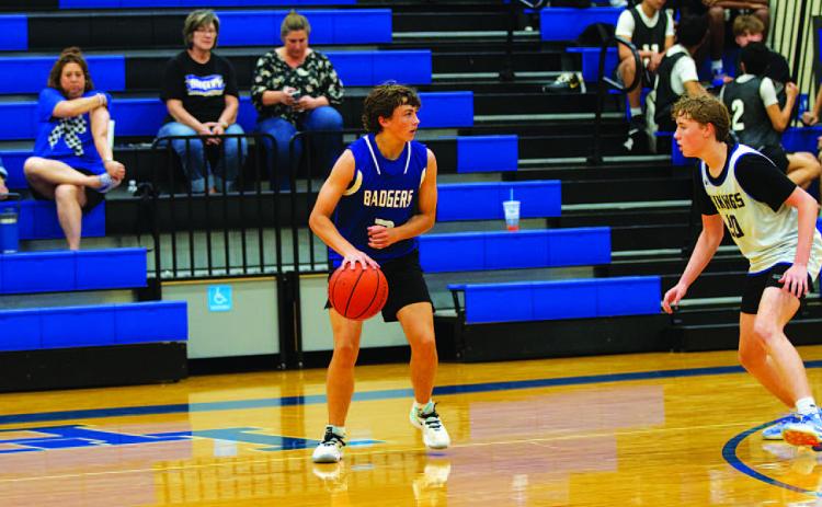 Ty Borchardt dribbles out on the perimeter during a spring league basketball game. HUNTER KING | DISPATCH RECORD