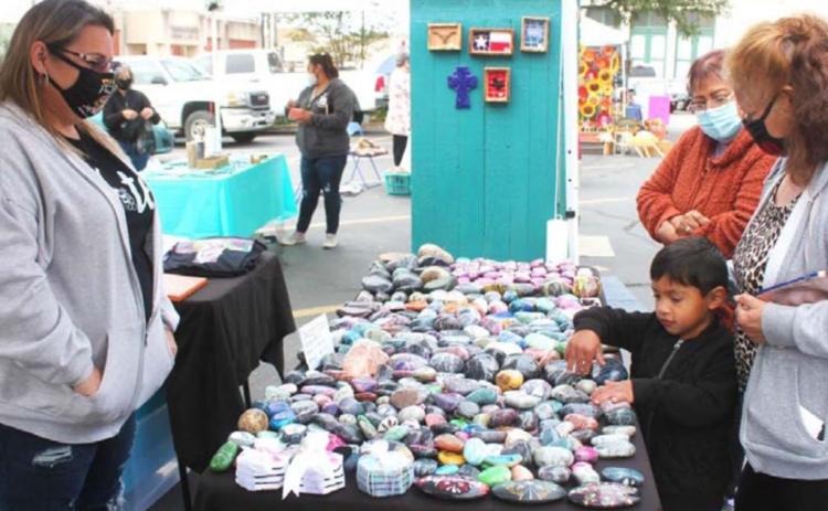 Visitors browse through Christine McDaniel’s painted rocks at her Lampasas Farmers’ Market stand last fall. Market organizer Jerry Hanson plans to continue – and expand – the produce and craft market this year on the downtown square. FILE PHOTO