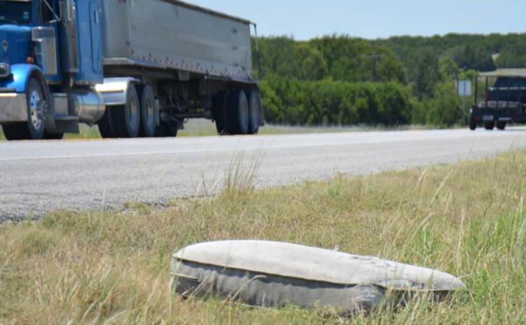 A discarded mattress sits in the grass beside U.S. Highway 183/U.S. Highway 190 between Lampasas and Lometa. County roads also have experienced illegal dumping in several areas, according to members of the Lampasas County Commissioners Court. MONIQUE BRAND | DISPATCH RECORD