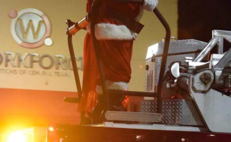 Santa and Mrs. Claus appear on a fire engine at the finale of the Holidazzle Parade. ALEXANDRIA RANDOLPH | DISPATCH RECORD