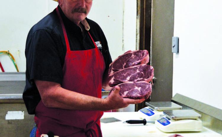 Stephen Meyer of M&amp;M Butcher Block displays some of the prime cuts of beef he plans to serve when his M&amp;M Steakhouse concept opens neext year on the courthouse square. Meyer is in the process of purchasing the former Eve’s Cafe building. After renovation, the steakhouse will open for dinner and feature high-quality steaks, traditional sides, and local wines and craft beers. ERICK MITCHELL | DISPATCH RECORD