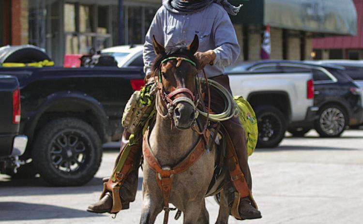 Jeremy Robinson rides his horse Trooper through downtown Lampasas on Wednesday. Robinson is nearing the end of a trek across Texas to raise awareness about veteran homelessness. His ultimate goal is to build a homestead and equine center where veterans could stay as long as needed, grow their own food and experience the “brotherhood” with others they experienced while in the military. HUNTER KING | DISPATCH RECORD
