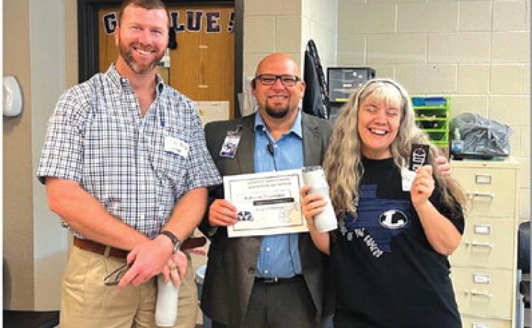 COURTESY PHOTO Clay Phillips of Texas Farm Bureau Insurance, at left, joins Lampasas High School Assistant Principal Ryan Race in congratulating Rebecca Veroneau on her selection as the campus’ Teacher of the Month for August. “She is a problem-solver with a heart of gold, and we are blessed to have her,” Race said of the Life Academics teacher.