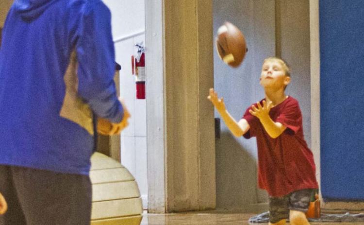 Football camp draws big turnout despite rain