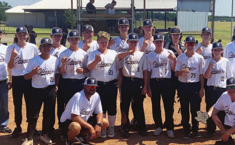 The Sluggers pose for a photo after winning district, and they will be on to the state tournament next week. COURTESY PHOTO