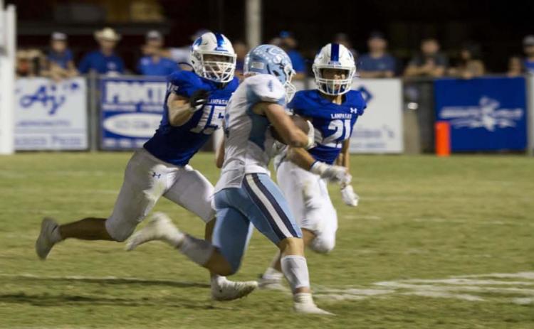 Case Brister and Ethan Moreno pursue the China Spring runner during the matchup with the Cougars last Friday. HUNTER KING | DISPATCH RECORD