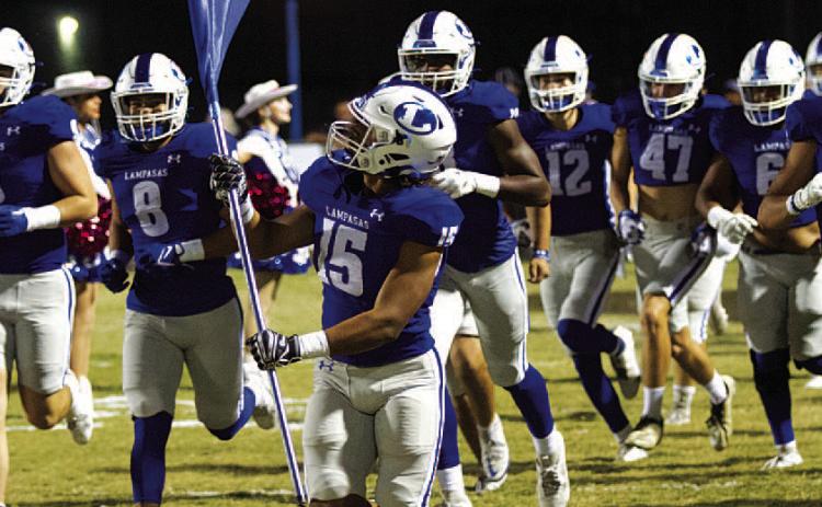 HUNTER KING | DISPATCH RECORD Dailan Fagan leads the Badgers onto the field before every game.
