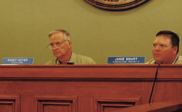County Judge Randy Hoyer, left, and Commissioner Jamie Smart listen to discussion about changing language in the burn ban to permit the use of fireworks. HUNTER KING | DISPATCH RECORD