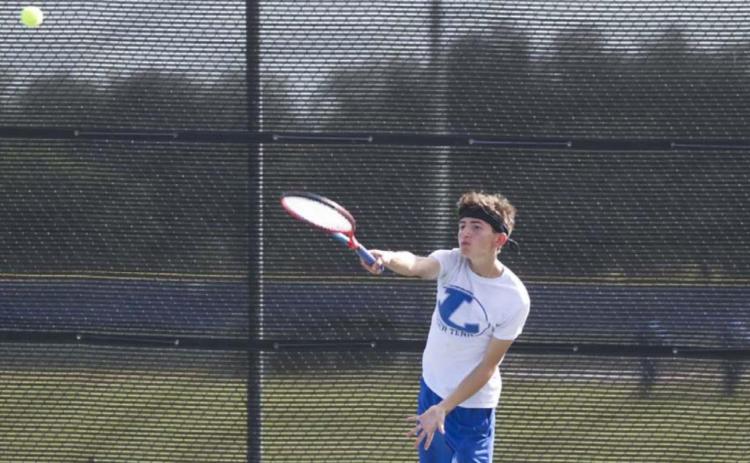 Clayton Shaw follows through on a serve during a previous match for the Badger tennis squad. HUNTER KING | DISPATCH RECORD