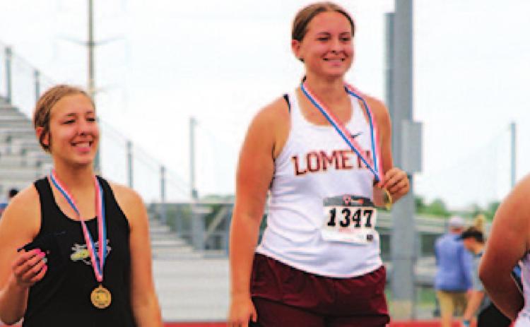 Sierra Tower stands atop the podium at the regional track meet after winning the discus event. JESSICA MALDONADO | DISPATCH RECORD