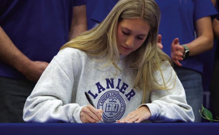 Breana Pelbath signs her letter of intent to Lander University. HUNTER KING | DISPATCH RECORD