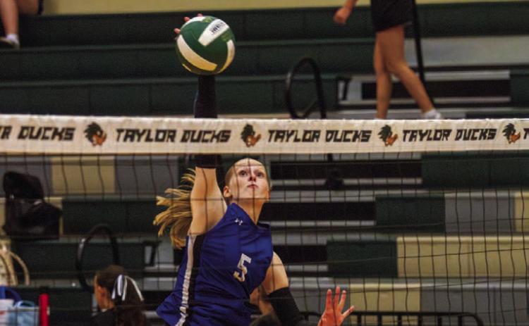 Outside hitter Mattie McBeth finishes her swing into a kill, one of 12 she had in the four-set win over Taylor on Tuesday. McBeth has amassed over 250 career kills with the Lady Badgers. ANA SOFIA MEYER | DISPATCH RECORD