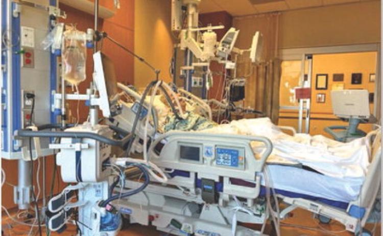 Local realtor Ron Kuker lies in a Houston hospital bed in the Intensive Care Unit before receiving a heart transplant. DEBBIE KUKER | COURTESY PHOTO
