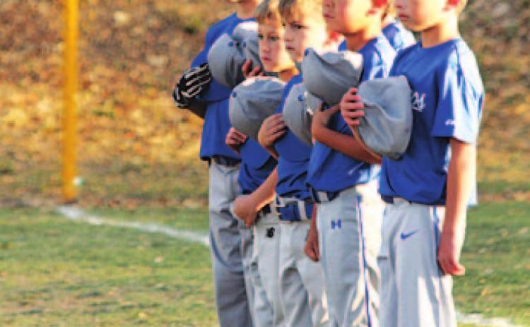 Youth ball players stand for the national anthem on opening day. COURTESY PHOTO